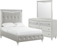 a white bedroom with a bed, dresser and mirror