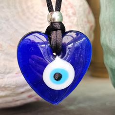 "EVIL EYE PROTECTION PROTECT YOUR LOVE NAZAR BONCUK In Turkey, it is known by the name nazar boncuğu (the latter word being a derivative of boncuk, \"bead\" in Turkic, and the former borrowed from Arabic), in Greece is known as μάτι (the evil eye). In Persian and Afghan folklore, it is called a cheshm nazar (Persian: چشم نظر) or nazar qurbāni (Persian: نظرقربانی). EVIL EYE HEART NECKLACE MADE IN THE TRADITIONAL TURKISH WAY. ONE SUPPLIED PICKED AT RANDOM FOR YOU ALL ARE UNIQUE. Pendant Diameter i Blue Jewelry With Heart Charm For Gifting, Blue Heart Charm Jewelry As A Gift, Blue Heart Charm Jewelry As Gift, Blue Heart Charm Jewelry For Gift, Blue Heart Charm Jewelry Gift, Spiritual Blue Jewelry With Heart Charm, Blue Spiritual Heart Pendant Jewelry, Spiritual Heart Beads Necklaces As Gifts, Spiritual Blue Heart Pendant Jewelry