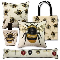 three pillows and two bags with bees on them