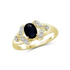 a yellow gold ring with an oval sapphire and diamonds