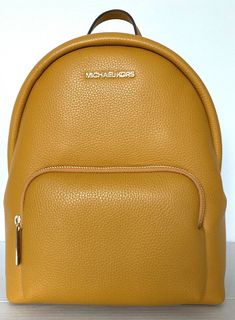 New with tags 100% Authentic Michael Kors  Erin Medium Backpack Marigold with Gold tone hardware Style # 35FOGERB2L The Erin backpack promises both style and function in a streamlined, easy-to-wear shape that’s designed for any lifestyle. Pebbled leather construction offers luxe texture, while the spacious interior will effortlessly stow everything from a tablet to a pair of flats. Pebble Leather 26"-30" adjustable shoulder straps Interior details: iPad compartment, back zip pocket and front sli Michael Kors Gold Bag With Adjustable Strap, Gold Michael Kors Bag With Adjustable Strap, Gold Leather Travel Backpack, Gold Luxury Backpack, Gold Standard Backpack, Classic Gold Michael Kors Bag, Gold Standard Backpack For Everyday Use, Travel Bags In Yellow Gold With Gold-tone Hardware, Gold Backpack For Daily Use