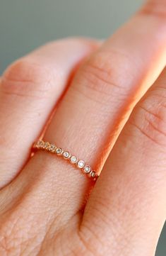 a woman's hand with a diamond ring on it