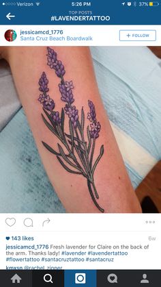 a tattoo with lavender flowers on the arm