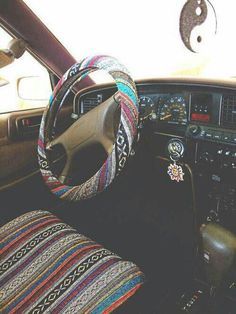 the interior of a car with steering wheel and dash board covers on it's dashboard