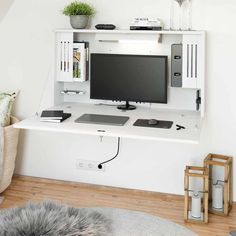 a white desk with a computer monitor and keyboard