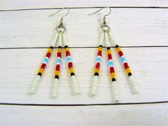 Tribal Seed Bead Earrings, Native Indian Inspired, Native American Style, Traditional Western Style Long dangle Native American beaded earrings accented with medicine wheel colors. Free Shipping First Class Mail with NO TRACKING! Matching Necklace ~ https://www.etsy.com/listing/753157143 💜Visit my store for more Awesome finds💜 https:www.etsy.com/shop/DJsWrapBracelets Southwestern Style White Jewelry With Dangling Beads, White Round Bead Southwestern Earrings, Southwestern Style White Beaded Dangle Earrings, Southwestern Tiny Beads Dangle Earrings, Native Anerican Earrings, Cherokee Beaded Earrings, Nickel-free Southwestern Style Festival Earrings, Southwestern Style Multicolor Nickel-free Beaded Earrings, Beaded Earrings Native