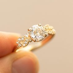 a person holding a diamond ring in their hand