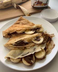 a white plate topped with lots of food on top of a table