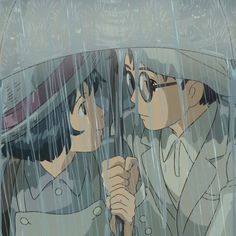 two people standing under an umbrella in the rain