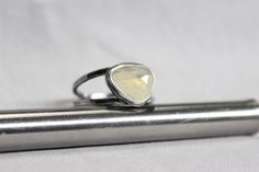 Stunning rose cut Ethiopian opal with beautiful fire with an open back setting, finished with a hammered sterling silver double band(1.75 x 1.25mm). This ring has a lightly oxidized/brushed finish. * Ethiopian opals are HYDROPHANE opals. When they get wet, they lose their fire as they absorb water. You dry them naturally, and the fire comes back within hours or a few days. * Like other gemstones, avoid rough/abrasive surfaces, high heat, chemicals(i.e. oils, perfumes, harsh household cleaners, e Modern Sterling Silver Opal Ring For Wedding, Minimalist Silver Opal Ring, Modern Sterling Silver Opal Ring Gift, Modern Sterling Silver Opal Ring For Gift, Ring Pearl Modern, Opal Band, Sterling Silver Stacking Rings, Silver Stacking Rings, Hammered Sterling Silver