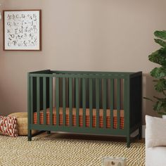 a baby crib in the corner of a room with a rug on the floor