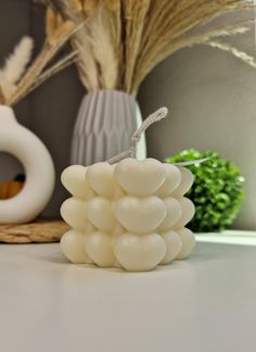 a white candle sitting on top of a table