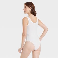 Update your wardrobe with the Double-Scoop Bodysuit from A New Day™. This sleeveless bodysuit is made of a soft fabric blend with added spandex for a comfortable fit that moves with you as you go about your day, while its solid-hued silhouette with allover ribbing offers textural dimension to your look. The pullover bodysuit has a scoop neckline at the front and back with reinforced stitched detailing on top and around the arm holes for some extra flair. Second-skin Elastane Bodysuit For Loungewear, High Stretch Sleeveless Bodysuit For Loungewear, Spring Elastane Bodysuit For Loungewear, White Scoop Neck Elastane Bodysuit, Sleeveless Solid Color Bodysuit For Loungewear, Casual Second-skin Seamless Bodysuit, Spring Sleeveless Bodysuit With Seamless Construction, Sleeveless Seamless Bodysuit For Spring, Spring Sleeveless Seamless Bodysuit