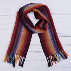 Bring the beauty of an Andean rainbow to your wardrobe with this scarf from Peru. Designed and handwoven of 100% alpaca by the talented artisans of the Ulloa Family the soft scarf features bright multicolored stripes along its length completed at the ends with fringes. Handwoven Alpaca Winter Scarf, Handwoven Alpaca Scarves For Winter, Handwoven Alpaca Scarves For Fall, Fall Alpaca Handwoven Scarves, Fall Handwoven Alpaca Scarf, Bohemian Handwoven Alpaca Scarves, Bohemian Alpaca Scarves For Winter, Bohemian Multicolor Woven Scarves, Multicolor Woven Winter Scarf