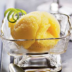 a glass bowl filled with yellow ice cream