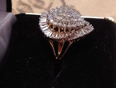 "This ring is gorgeous! It is from an Estate in New York City. The owner was an actress in the New York Theatre, and loved large diamond rings. This definitely fits the bill! It is a \"Ballerina\" design ring. The description of a Ballerina ring is \"fanciful and a distinctive style of gems\" in this case Diamonds! The cluster of Diamonds in the center simulates the flowing movement of a Ballerina dancing, and creates a swirling effect of Diamonds on the finger. Baguettes are usually used in thi Yellow Gold Cluster Diamond Ring For Anniversary, Yellow Gold Diamond Cluster Ring For Anniversary, Anniversary Yellow Gold Cluster Diamond Ring, Pear-shaped Vs Clarity Ring For Proposal, Diamond White Emerald Cut Cluster Ring For Anniversary, Pear-shaped Diamond Cut Cluster Ring For Wedding, Vvs Clarity Pear-shaped Diamond Ring For Anniversary, Dazzling Emerald Cut Cluster Ring For Anniversary, Cluster Diamond Ring With Vs Clarity For Promise