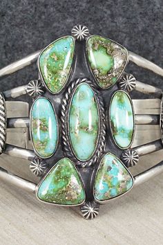 This exquisite Sonoran Gold turquoise and sterling silver bracelet was made by Navajo silversmith Raymond Delgarito. The inside is signed R and partially stamped sterling.Size: 5 3/8" (will fit up to a 6 5/8" wrist)Gap: 1 1/4"Width: 2"Free shipping on all orders! We ship with USPS and always include tracking. All orders ship within a day of payment.Returns are accepted up to 30 days after you receive your order. Just send us a message. Our shop offers cash back or store credit. The item must be Unique Turquoise Sterling Silver Bracelet Collectible, Artisan Sterling Silver Turquoise Bracelet Collectible, Southwestern Sterling Silver Bracelet With Turquoise Inlay, Southwestern Turquoise Sterling Silver Cuff Bracelet, Taos Art, Turquoise Jewellery, Nickel-free Southwestern Sterling Silver Bracelet, Southwestern Style Blue Nickel-free Cuff Bracelet, Southwestern Nickel-free Turquoise Jewelry