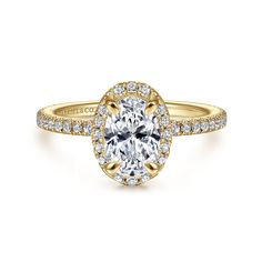 a yellow gold engagement ring with an oval cut diamond surrounded by pave set diamonds