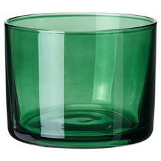 a green glass vase sitting on top of a table