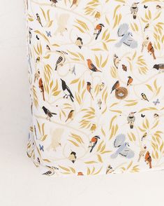 a white box with birds and leaves on it