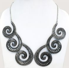 Six engraved silver metal alloy spiral in a vintage oxidized old world look., bound together by metal hooks to create a uniquely handcrafted masterpiece. An urban fashion look for any age, necklace design is a modern look. It closes with a lobster claw clasp at the back. It`s a great accouterment to any of your modern fashion dresses or tops. Adjustable Spiral Jewelry With Oxidized Finish, Traditional Spiral Silver Jewelry, Traditional Silver Spiral Jewelry, Silver Spiral Bohemian Necklace, Handmade Vintage Spiral Jewelry, Bohemian Silver Spiral Necklace, Adjustable Silver Necklace With Antique Finish, Traditional Spiral Metal Jewelry, Handmade Spiral Silver Necklace