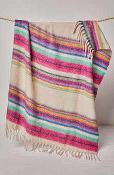 a multicolored towel hanging on a rope