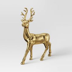 a gold statue of a deer on a white background