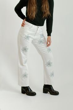 This is a 100% Cotton, Jean. It is embroidered with our signature brand logo flower. It fits mid-waist with wide-leg at the bottom of the jean. It can be styled in many ways and weather. Mix and match with some sneakers, boots, or heels. Trendy Cotton Flare Jeans For Winter, Trendy Winter Flare Jeans In Cotton, Trendy Straight Leg Pants With Floral Embroidery, Casual Embroidered Cotton Flare Jeans, Trendy Embroidered Relaxed Fit Jeans, Cotton Flare Jeans With Straight Leg, Trendy Embroidered Pants For Fall, Winter Cotton Flare Jeans With Straight Leg, Fall Floral Embroidered Wide Leg Jeans