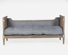 an antique style couch with grey cushions