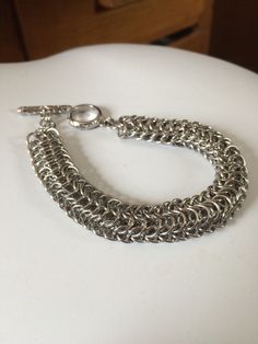 This is the Dragonback Chainmaile pattern in stainless steel rings. This is a very complex pattern as well but also feels amazing on the skin is very fluid. Stainless steel won't tarnish, fade or chip. It's a strong and elegant material that remains looking great through the times Hypoallergenic Silver Chain Link Bracelet, Metal Chain Link Bracelet For Jewelry Making, Metal Box Chain Bracelet, Metal Chainmail Bracelet, Silver Chainmail Chain Bracelet As Gift, Stainless Steel Jewelry Making Jump Rings, Silver Chainmail Bracelet As A Gift, Silver Metal Box Chain Bracelet, Hypoallergenic Metal Bracelets For Jewelry Making