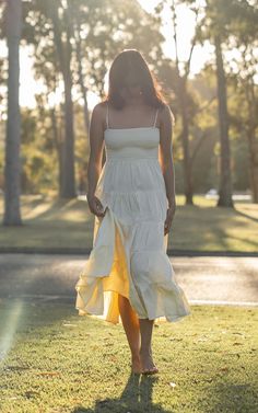 Be summer shining bright in our Kaha Midi Dress! In this breezy soft linen sundress, you'll be sure to brighten everyone's day. Pair with your favourite sandals and a cute hair braid! KEY DETAILS: * Soft pale yellow linen fabric - Highly breathable. Perfect for hot weather * Smocked top for comfort & a hugging waist * Adjustable tie straps * 4-Tier flare skirt * Midi dress length SIZE & FIT: Model wears AU 8. Model usually wears S/8 Cream Lace Midi Dress For Summer, Breezy Cotton Sundress For Brunch, Cotton Summer Sundress, Summer Midi Sundress, Sundress For Day Out, Summer Midi Dress With Spaghetti Straps For Day Out, Breezy Cotton Sundress For Beach Season, Linen Sundress For Day Out, Summer Beige Cotton Sundress