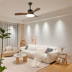 a living room filled with furniture and a ceiling fan