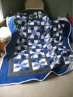 a blue and white quilt is on the floor