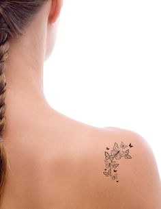 a woman with a tattoo on her back shoulder