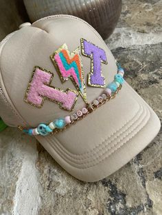 Best accessory for any cap with netting on the sides. These chains clip onto either side of the hat, and can be personalized. Choose your text, up to 8 letters. Bead pattern created in pastel or fall color pallet with peace signs, hearts, or candy accents. Hat not included! Packaged in a net pouch. Personalized Adjustable Trucker Hat For The Beach, Trendy Personalized Adjustable Hats, Handmade Multicolor Trucker Hat, Adjustable Multicolor Trucker Hat For Festivals, Multicolor Trucker Hat As A Gift, Multicolor Trucker Hat As Gift, Multicolor Trucker Hat One Size Fits Most As Gift, Multicolor One Size Trucker Hat As Gift, Trendy Multicolor Hats As Gifts