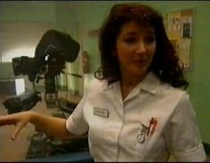 a woman in white uniform pointing at something