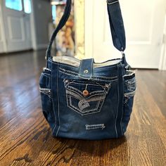 a denim purse with an owl embroidered on it