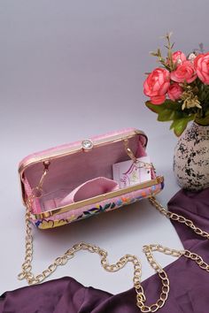 The excellent Parsi gara embroidery work is done on this clutch bag which you can use as a clutch and a sling with a long handle. It comes with a small and a big shoulder strap. It has one main compartment with a click closure. Carry this bag this festive season and look glamorous. Team this up with ethnic wear for a fashionable look. Color: Pink Size & Fit: Length: 8 inch Width: 2 inch Height: 5 inch Material: Silk Care: Wipe with a dry cloth Evening Bag With Multicolor Embroidery, Rectangular Shape, Multicolor Embroidered Evening Clutch Bag, Rectangular Bag With Multicolor Embroidery For Evening, Evening Rectangular Shoulder Bag With Multicolor Embroidery, Rectangular Evening Bag With Multicolor Embroidery, Evening Bag With Multicolor Embroidery, Rectangular Multicolor Embroidered Evening Bag, Evening Handheld Shoulder Bag With Floral Embroidery, Handheld Floral Embroidered Shoulder Bag For Evening