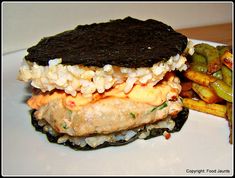 a sandwich and french fries on a white plate