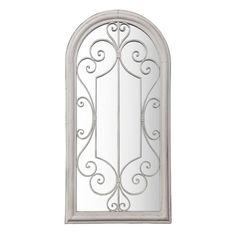 a white arched mirror with scroll designs on the front and back sides, hanging from a wall