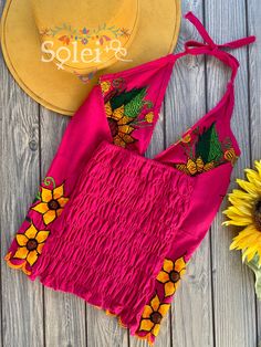 This Beautiful Sunflower Embroidered Halter Top is the perfect Top for Everyday use or a special event. It is comfortable, with elastic on the back and has a tie around the neck for an adjustable fit. This blouse comes in one size which fits sizes Small and Medium. Fitted Floral Embroidered Top For Summer, Fitted Floral Print Embroidered Top For Summer, Fitted Floral Embroidered Top For Festival, Fitted Embroidered Top For Summer Beach, Summer Embroidered Top With Floral Print, Fitted Summer Embroidered Top With Geometric Design, Multicolor Embroidered Floral Top For Summer, Fitted Summer Top With Geometric Embroidery, Multicolor Embroidered Floral Print Top For Summer