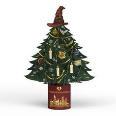 a small christmas tree with harry potter hat on it's head and decorations around the base