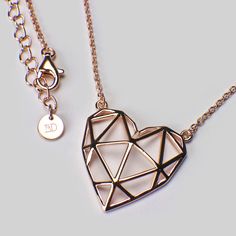 Geo-Heart is strong, she's complicated, she knows what she wants. The first necklace from our collection designed in-house, Geo-Heart follows the latest trend in geometric jewellery. Make a statement and wear her casually over a plain t-shirt or dressed up with a blouse. Either way, she rocks! Sterling silver with 18ct rose gold plating to 1.5 microns thickness. Jump rings allow the chain to be worn any length from 16 to 18 inches. Pendant measures 20 mm wide x 20 mm high. Geometric Heart, Heart Valentines, Geometric Jewelry, Plain Tshirt, Valentines Gift, Geometric Patterns, Gold Plated Sterling Silver, Heart Necklace, Rose Gold Plates