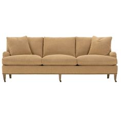 a beige couch with four pillows on top of it's back and legs, against a white background