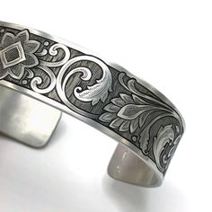 Hand Engraved Sterling Silver cuff with scrollwork inspired by both western culture and oriental rug design.  The cuff can be adjusted slightly by squeezing the bracelet, fitting an average wrist size around 7.5 inches. Contact me for custom personalized orders, thanks! Engraved Cuff, Moreno Valley, Western Culture, Western Jewelry, Velvet Bag, Sterling Silver Cuff, Silver Cuff, Hand Engraving, Rug Design