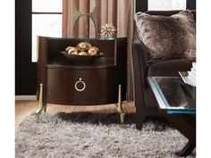 a living room scene with focus on the end table and chair, which has a glass top