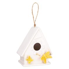 a white birdhouse with two yellow butterflies on it's front and back sides