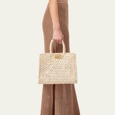 Ferragamo "The Studio" top handle bag in raffia-like cotton  Rolled top handles Open top with golden Gancini slider clasp closure  Interior, removable zip pouch bag  Feet protect bottom of bag  Approx. 9.4"H x 11.4"W x 5.7"D Made in Italy Elegant Straw Bag With Round Handle In Natural Color, Chic Crochet Straw Bag With Top Handle, Luxury Rectangular Straw Bag With Top Carry Handle, Luxury Straw Bag With Top Carry Handle, Elegant Top Handle Crochet Bag For Vacation, Elegant Crochet Top Handle Bag For Vacation, Woven Top Handle Straw Bag, Natural Straw Shoulder Bag With Gold-tone Hardware, Elegant Woven Top Handle Straw Bag