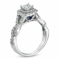 a white gold engagement ring with blue and white diamonds on the band, set in 18k white gold