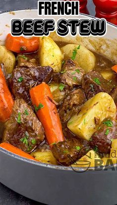 a pot full of beef stew with carrots and potatoes